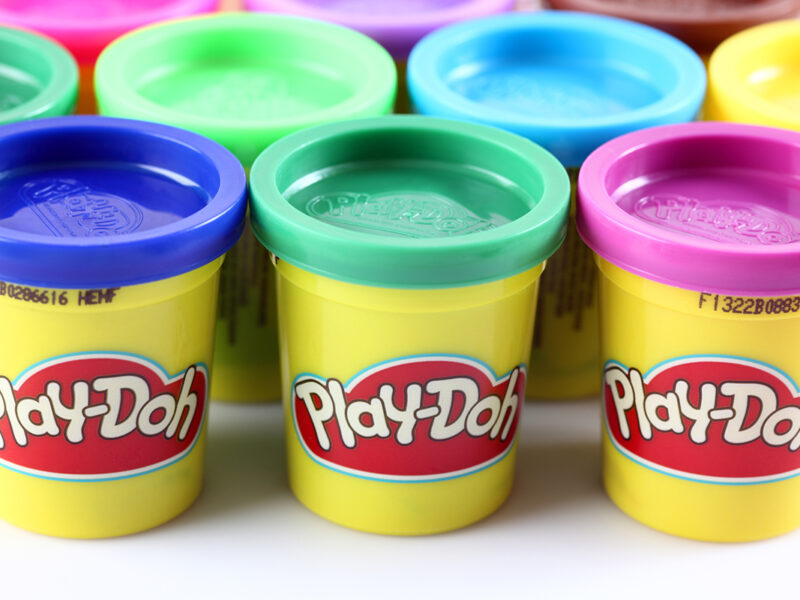 Tambov, Russian Federation - Jule 28, 2012 Containers of various colored Play-Doh modeling compound. Play-Doh is manufactured by Hasbro.